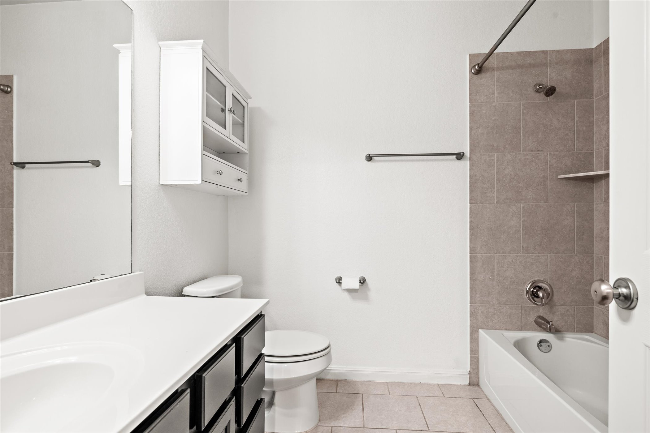7337 Menchaca Road, Unit #22 Austin, TX 78745 - Photo 19 of 25 Full bathroom on second floor featuring light tile flooring, vanity, and bathing tub / shower combination