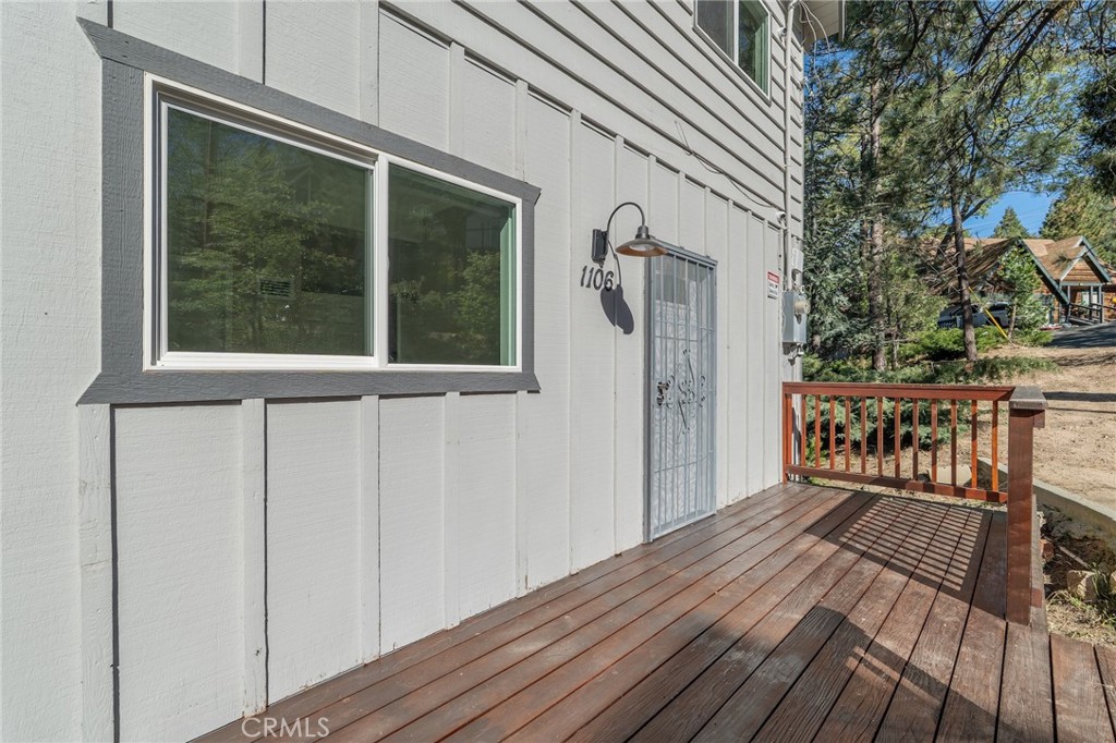1106 Grass Valley Road Lake Arrowhead, CA 92352 - Photo 17 of 57 a view of a balcony with wooden floor and fence