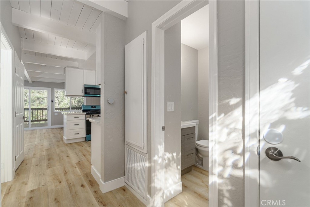 1106 Grass Valley Road Lake Arrowhead, CA 92352 - Photo 19 of 57 a kitchen with a refrigerator and white cabinets