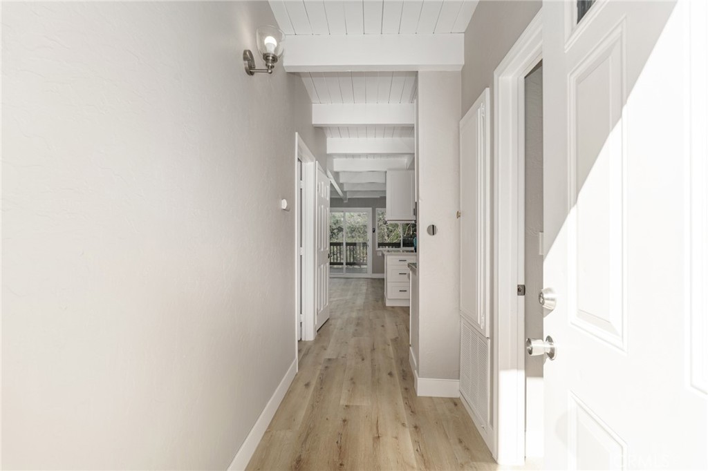1106 Grass Valley Road Lake Arrowhead, CA 92352 - Photo 20 of 57 a view of a hallway with wooden floor and a bathroom