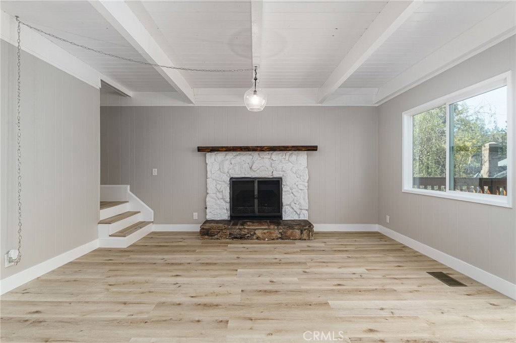 1106 Grass Valley Road Lake Arrowhead, CA 92352 - Photo 21 of 57 a view of an empty room with wooden floor and a window
