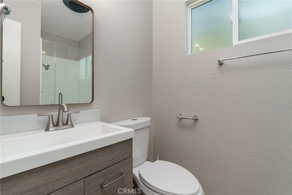 1106 Grass Valley Road Lake Arrowhead, CA 92352 - Photo 23 of 57 a bathroom with a sink a toilet and mirror