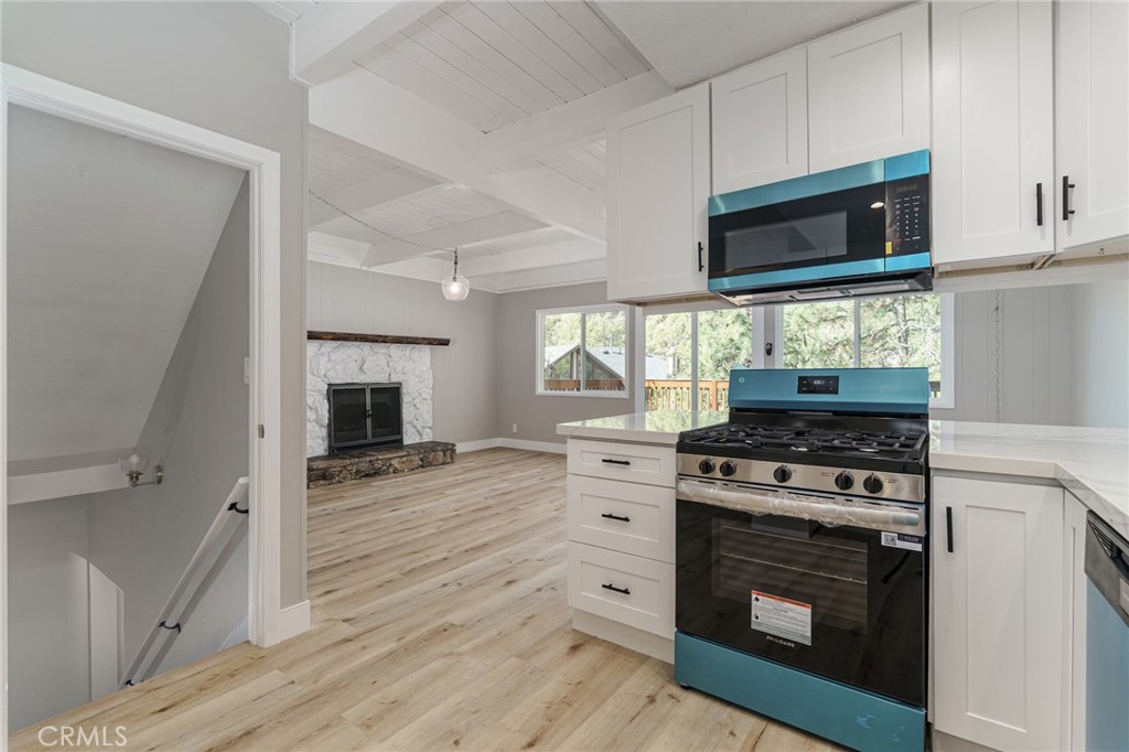 1106 Grass Valley Road Lake Arrowhead, CA 92352 - Photo 27 of 57 a kitchen with a stove and a microwave