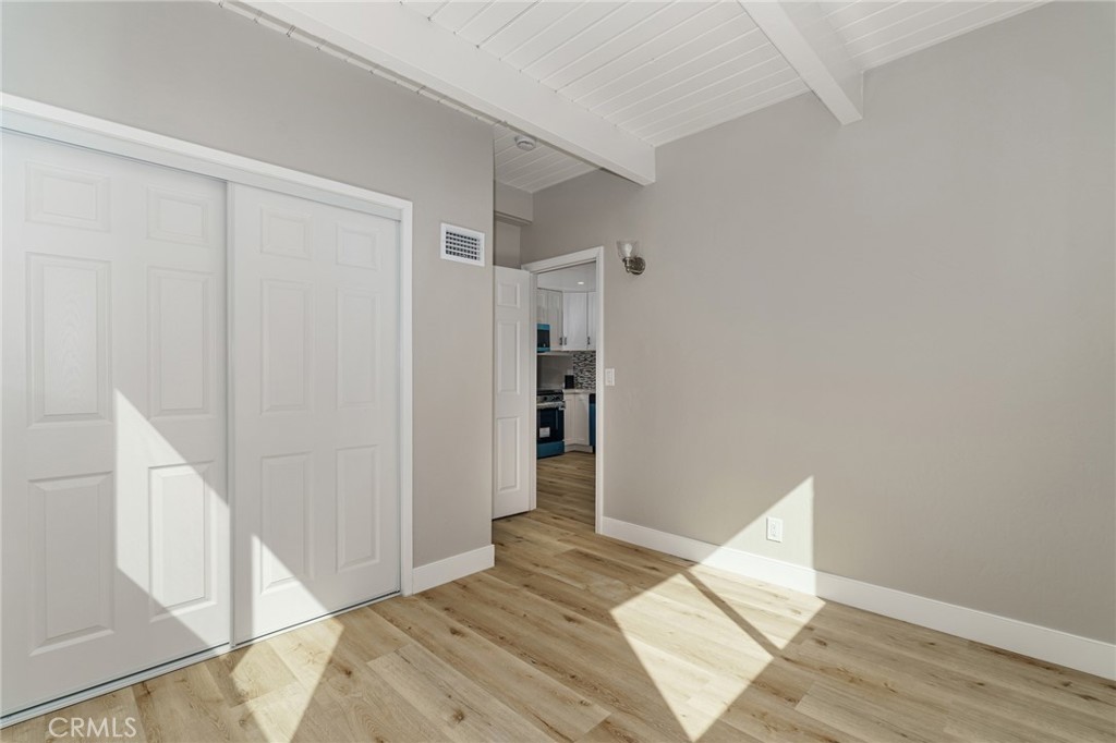 1106 Grass Valley Road Lake Arrowhead, CA 92352 - Photo 29 of 57 a view of an empty room with wooden floor and a window