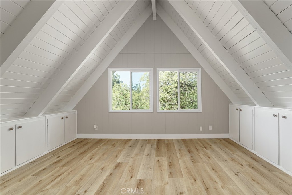 1106 Grass Valley Road Lake Arrowhead, CA 92352 - Photo 37 of 57 an empty room with wooden floor and windows