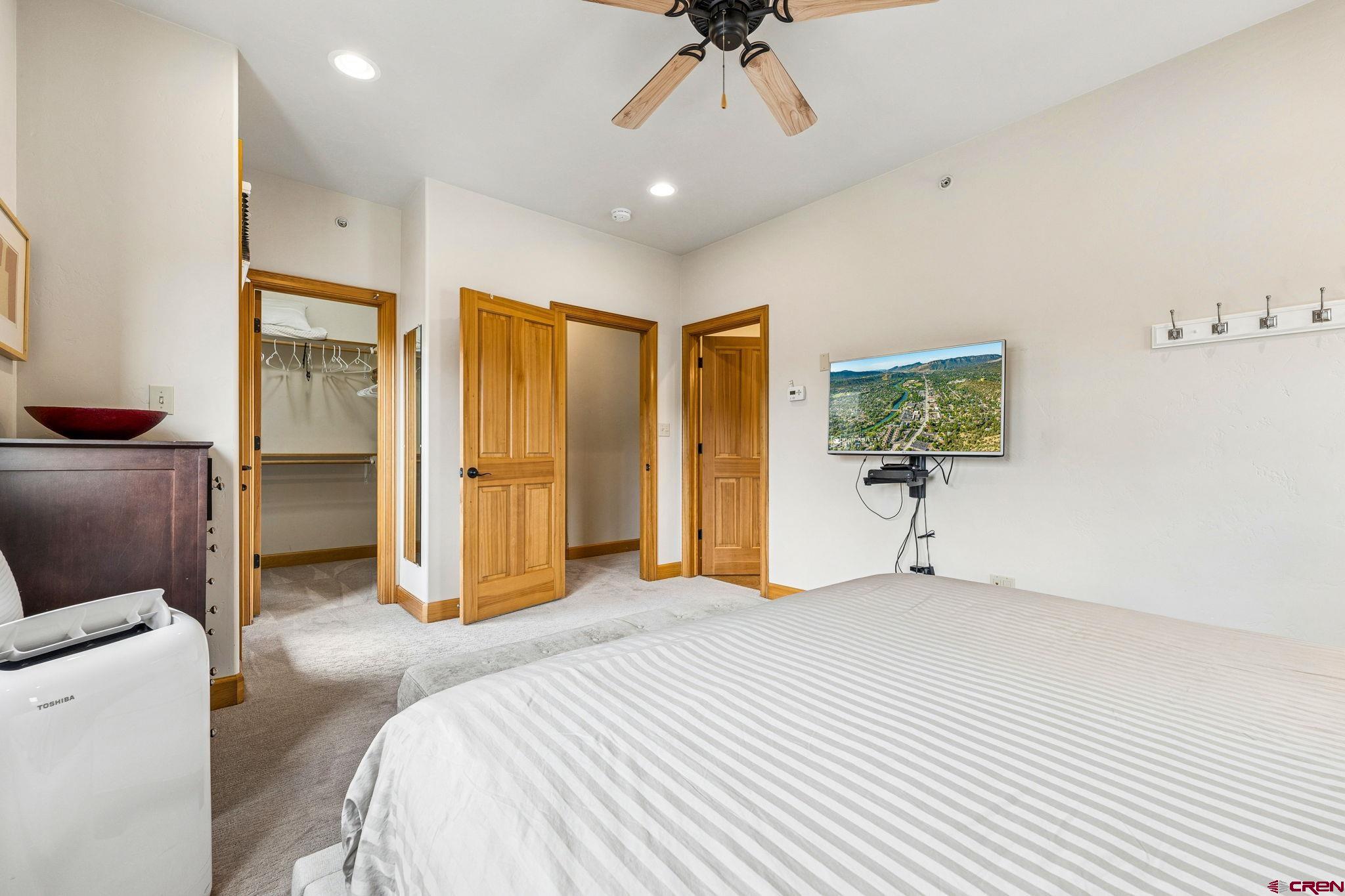 1422 Animas View Drive, Unit 55 Durango, CO 81301 - Photo 19 of 44 a spacious bedroom with a bed and a table in it
