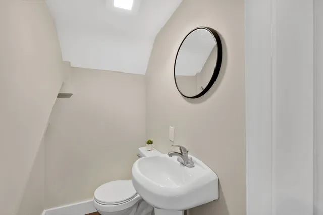 a view of a big room with wooden floor and windows