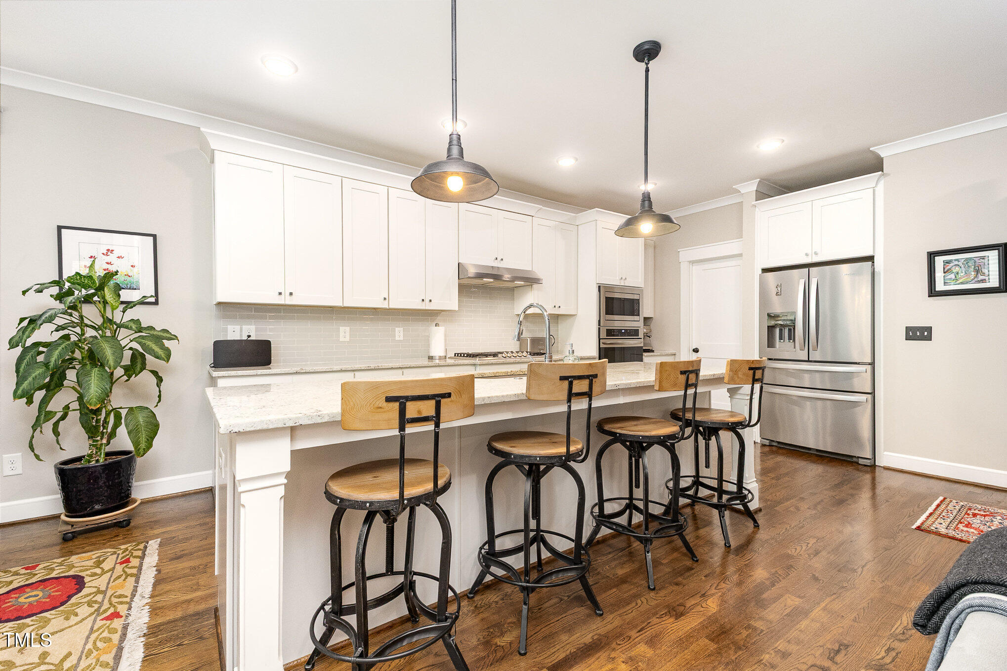 3608 Dixon Road Durham, NC 27707 - Photo 3 of 32 a kitchen with stainless steel appliances granite countertop table chairs refrigerator and microwave