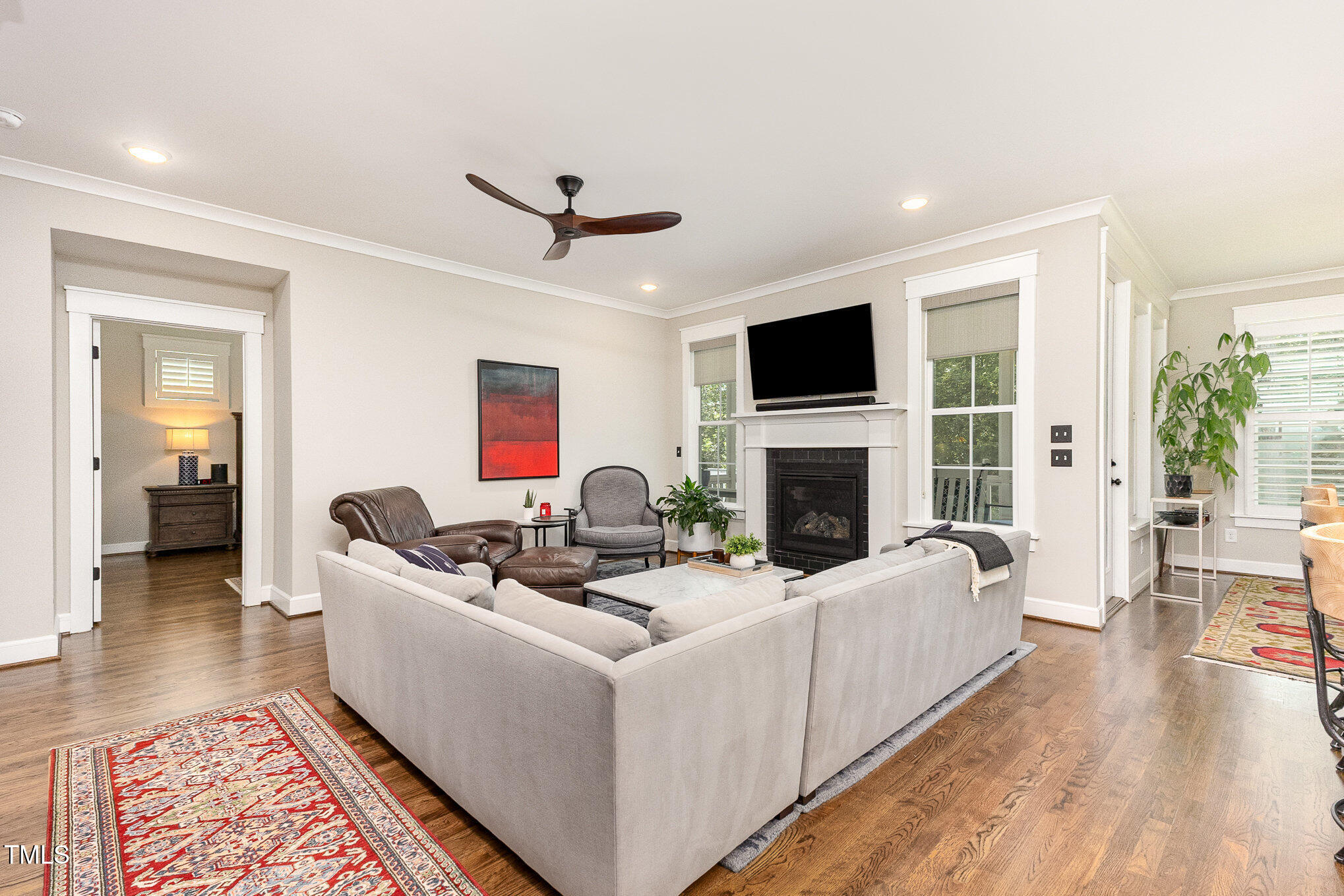 3608 Dixon Road Durham, NC 27707 - Photo 6 of 32 a living room with furniture a flat screen tv and a fireplace