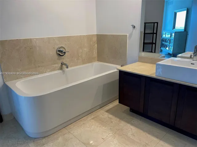 a bathroom with a bathtub and a sink
