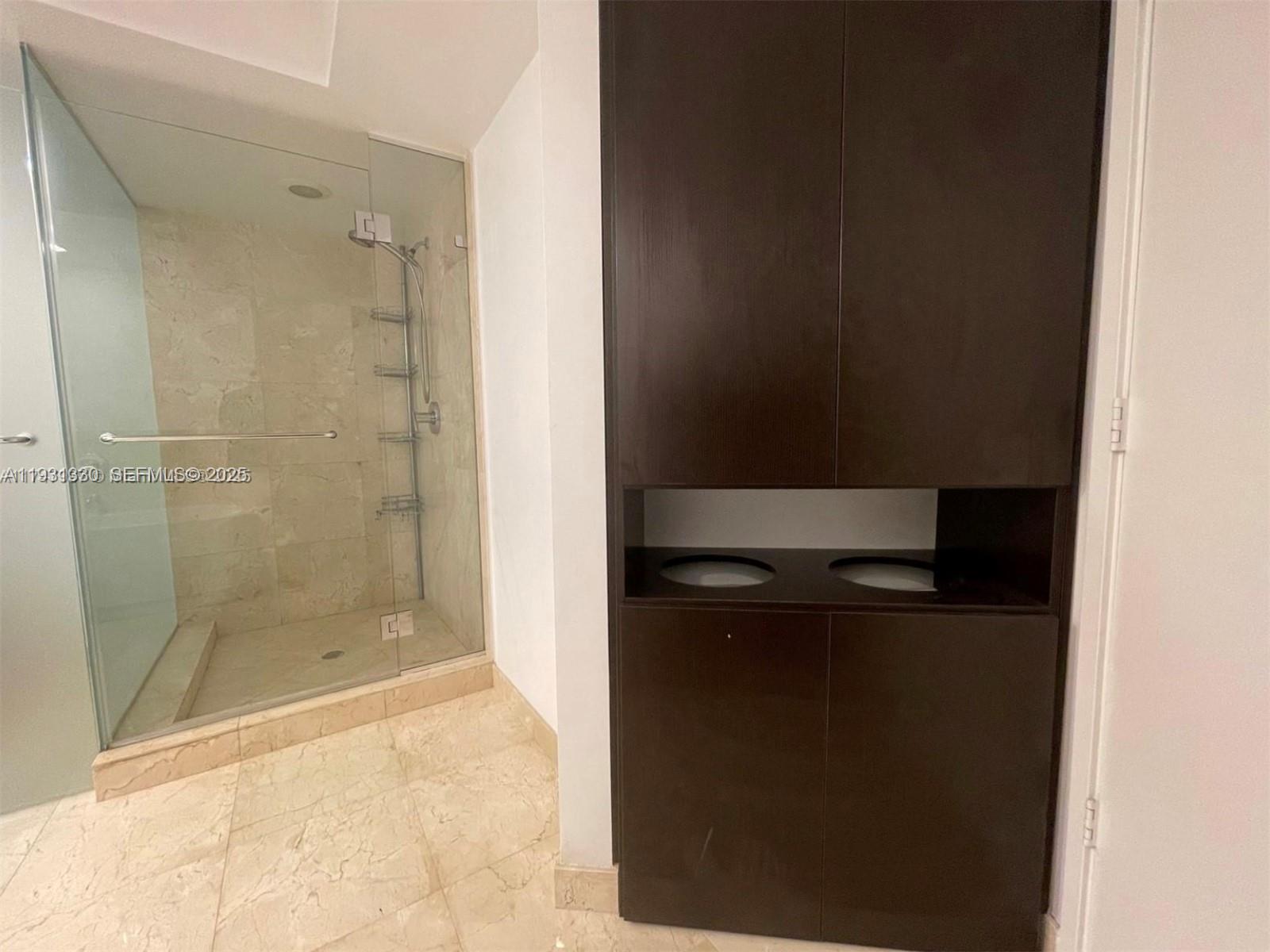 250 Sunny Isles Boulevard, Unit 31003 Sunny Isles Beach, FL 33160 - Photo 16 of 25 a bathroom with a shower and mirror