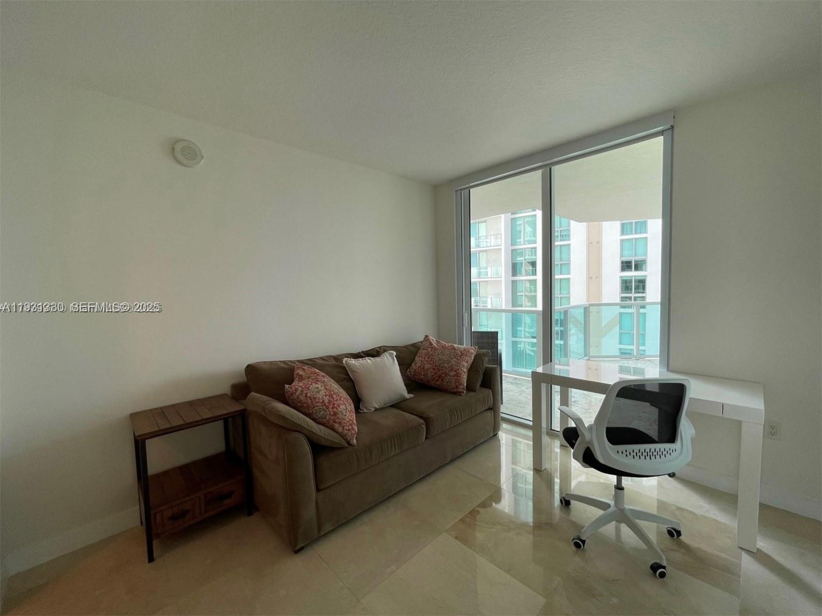 250 Sunny Isles Boulevard, Unit 31003 Sunny Isles Beach, FL 33160 - Photo 19 of 25 a living room with furniture and a window