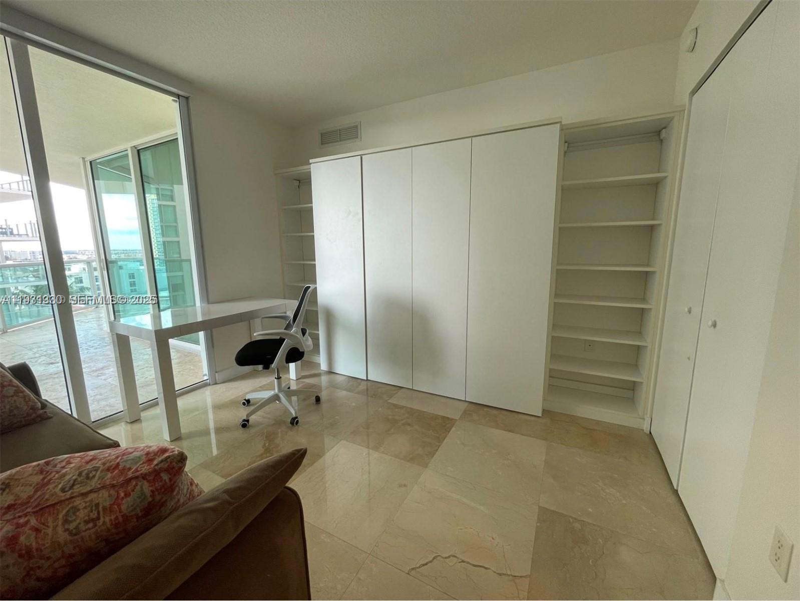 250 Sunny Isles Boulevard, Unit 31003 Sunny Isles Beach, FL 33160 - Photo 20 of 25 a room with furniture and a gate