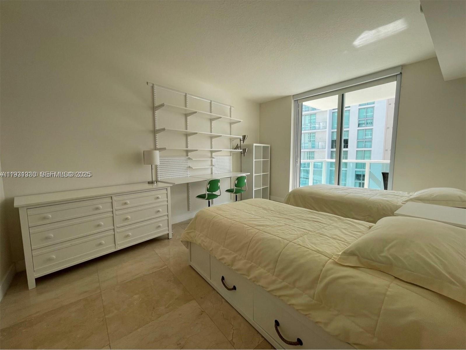 250 Sunny Isles Boulevard, Unit 31003 Sunny Isles Beach, FL 33160 - Photo 22 of 25 a bedroom with a bed and dresser
