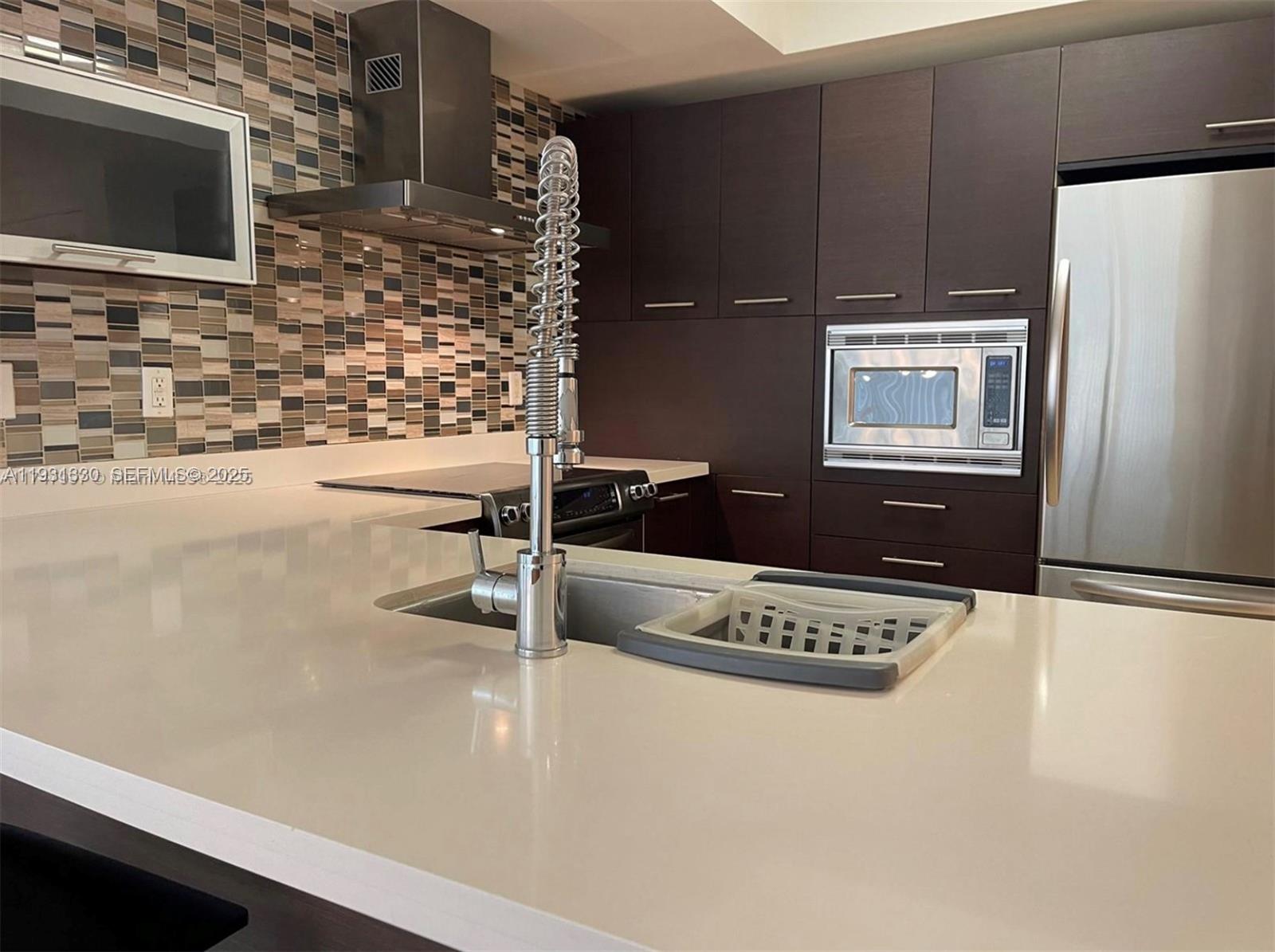 250 Sunny Isles Boulevard, Unit 31003 Sunny Isles Beach, FL 33160 - Photo 5 of 25 a view of kitchen with sink refrigerator and microwave