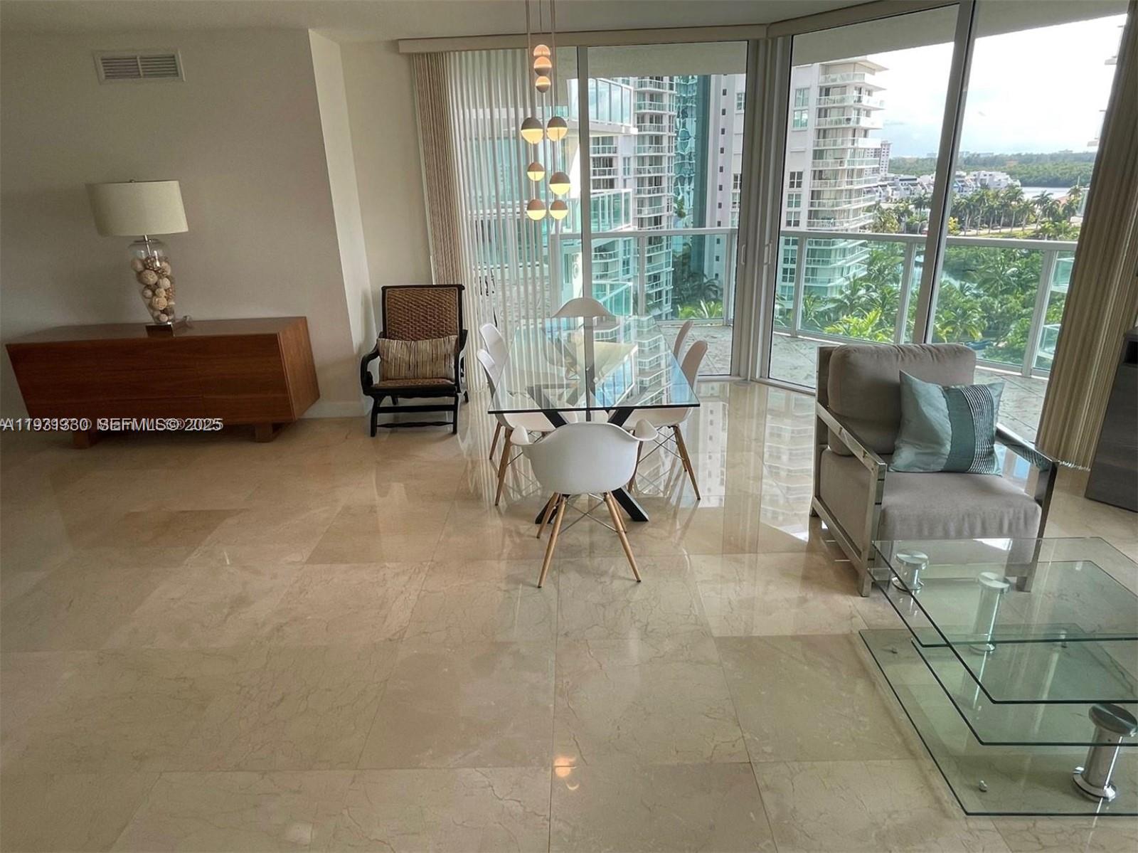 250 Sunny Isles Boulevard, Unit 31003 Sunny Isles Beach, FL 33160 - Photo 8 of 25 a living room with furniture and a floor to ceiling window