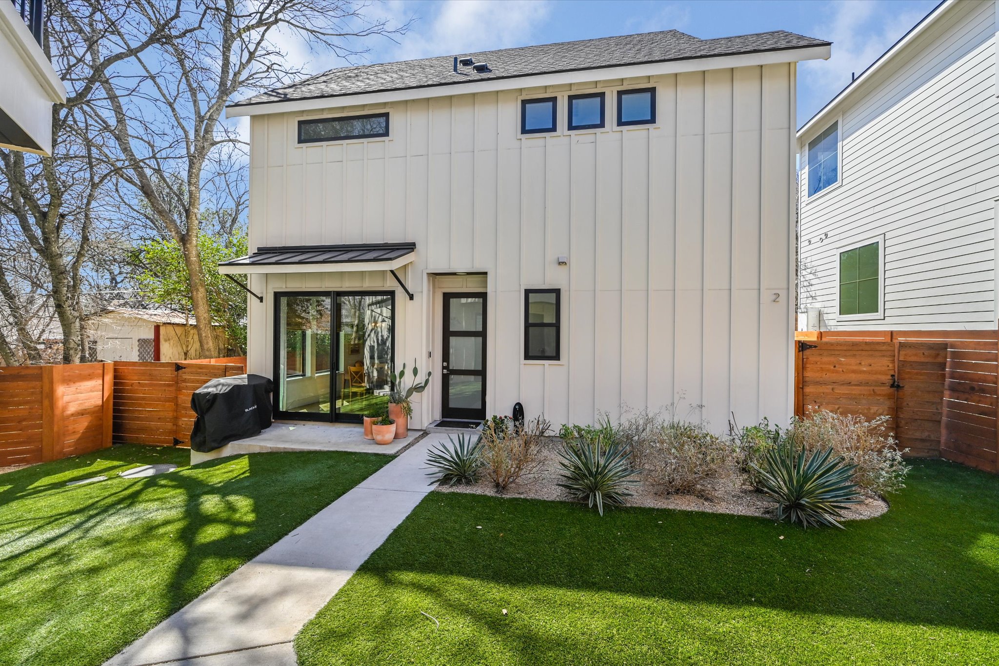 907 Redd Street, Unit 2 Austin, TX 78745 - Photo 2 of 20 The main home offers a spacious turfed yard! Turf is ideal for easy maintenance, is perfect for pet owners, and offers a year-round gorgeous yard! The main home also has sliding doors from the living area to the patio, perfect for hosting, entertaining and grilling out.