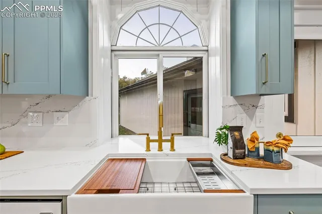 a kitchen with a sink and a stove next to a window