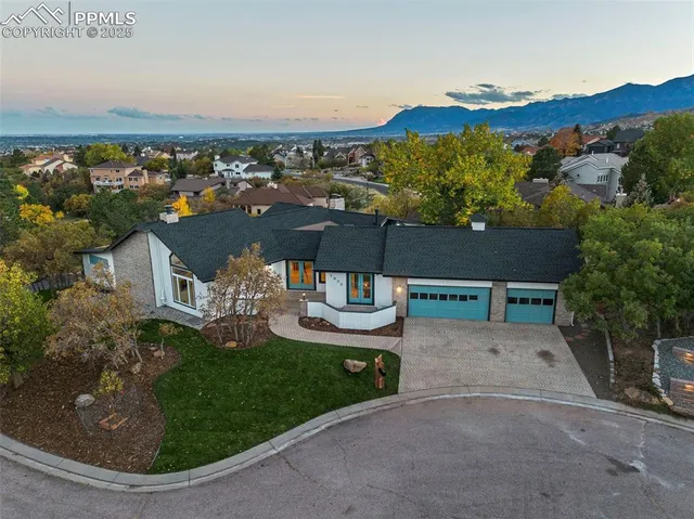 an aerial view of a house with garden space and houses