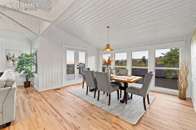 a dining room with a wooden table and chairs