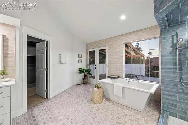 a bathroom with a tub sink and mirror