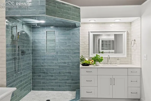 a bathroom with a shower sink and mirror