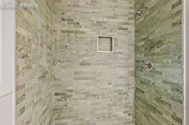 an empty room with sliding door and windows