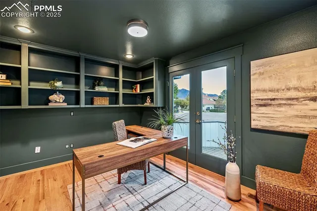 a view of a hallway with dining area wooden floor and a chandelier