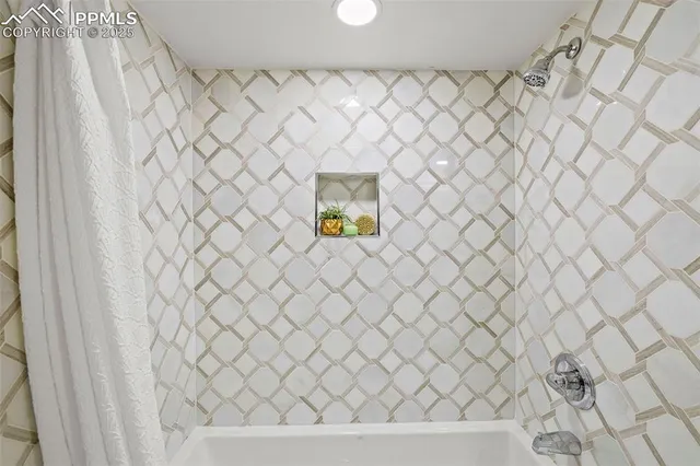 a dining room with furniture and a floor to ceiling window