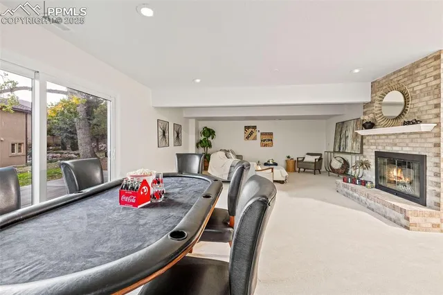 a living room with furniture a fireplace and a potted plant