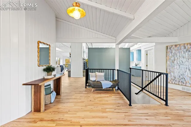 a view of a hallway with dining room and wooden floor
