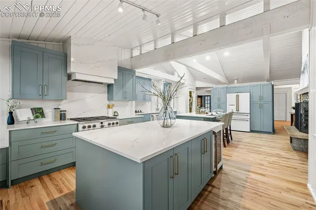 a kitchen with a stove a sink and a refrigerator