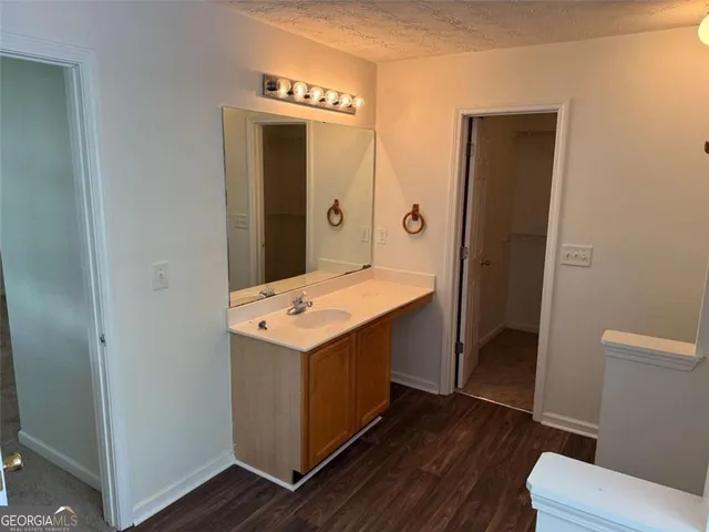 a bathroom with a tub shower and a sink