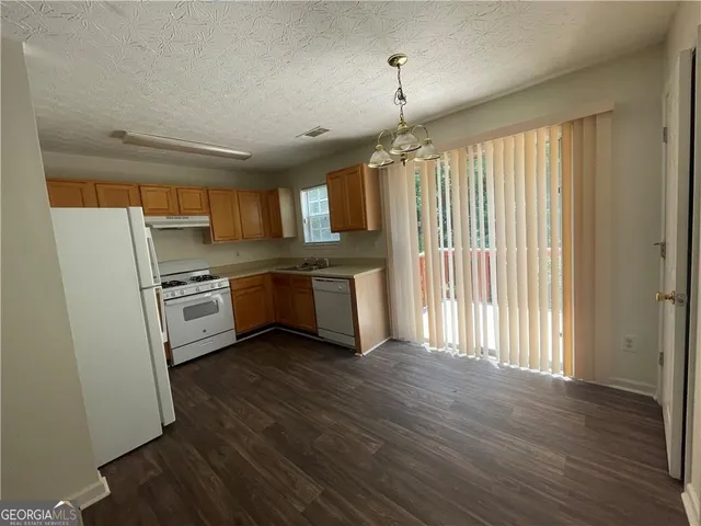 a kitchen with stainless steel appliances a stove a sink and a refrigerator