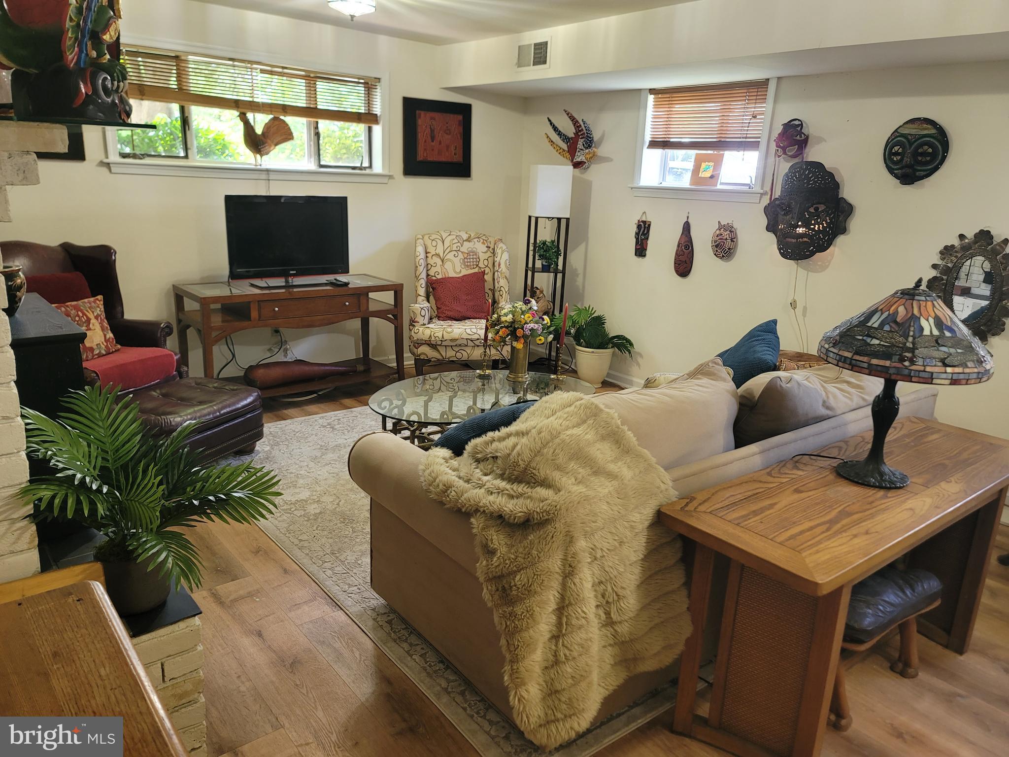6910 Gilbert Street Springfield, VA 22150 - Photo 15 of 29 a living room with couches and a flat screen tv with kitchen view