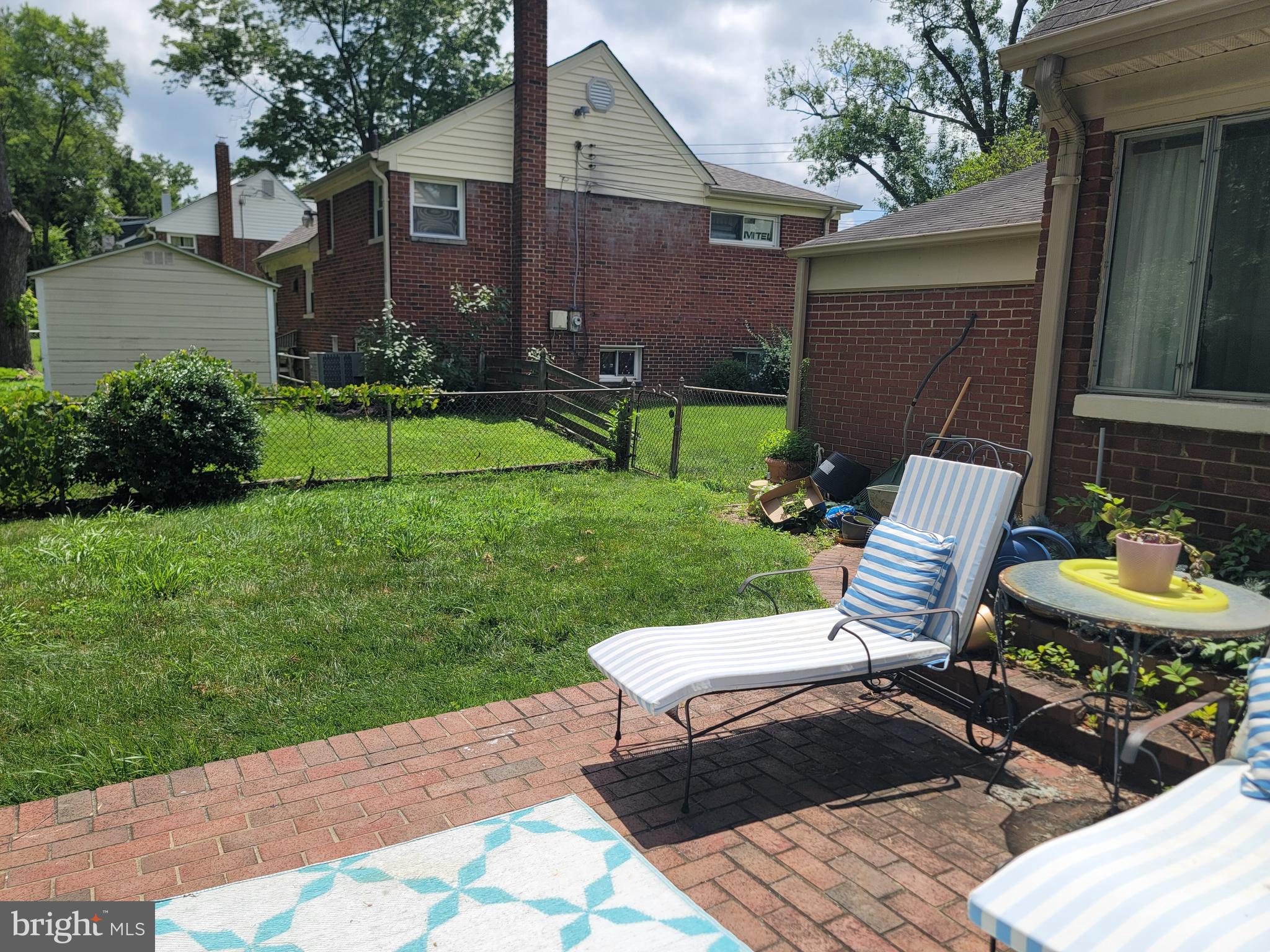 6910 Gilbert Street Springfield, VA 22150 - Photo 26 of 29 a view of a chair and table in backyard of the house