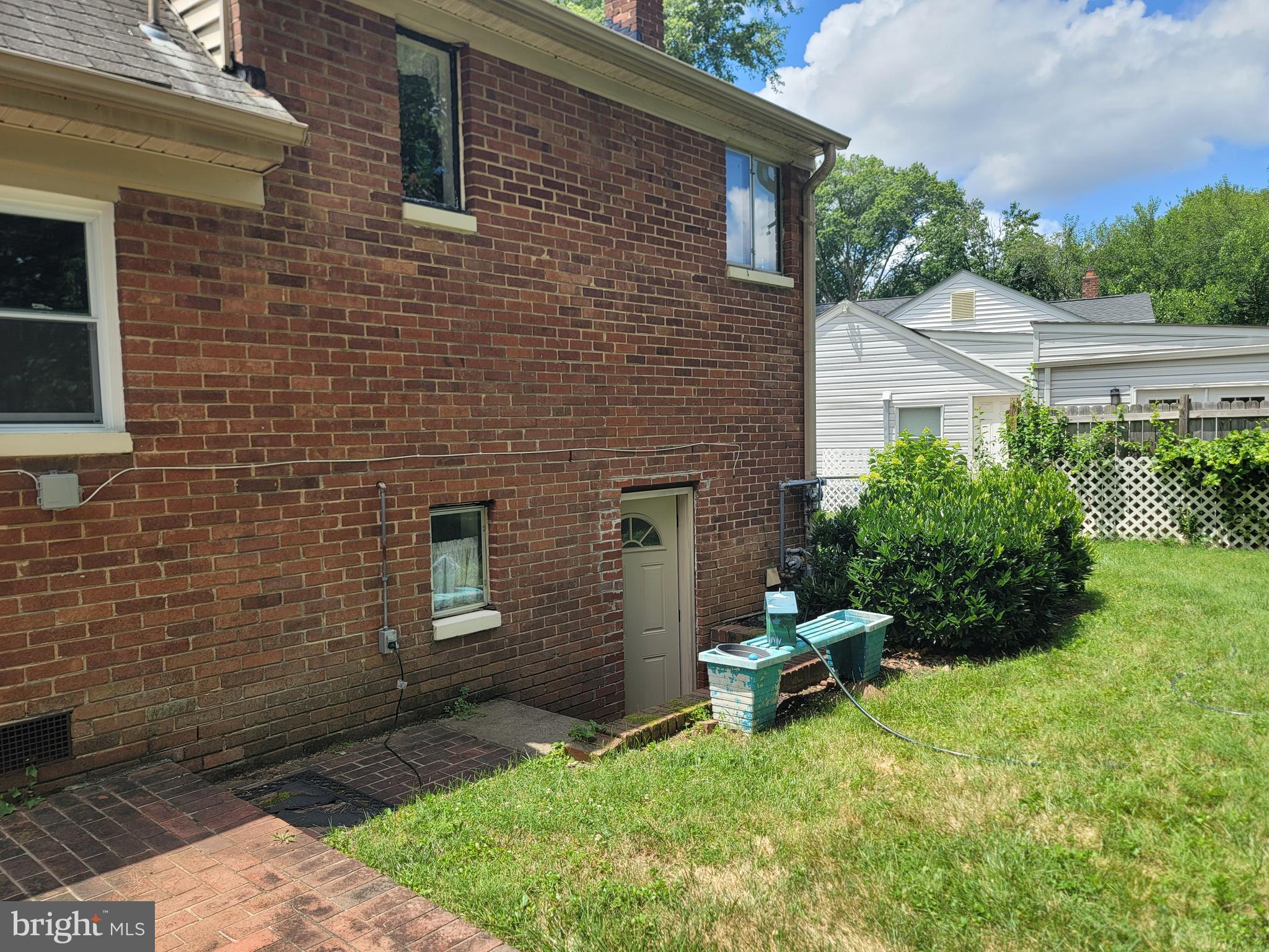 6910 Gilbert Street Springfield, VA 22150 - Photo 27 of 29 a backyard of a house with a garden and outdoor seating