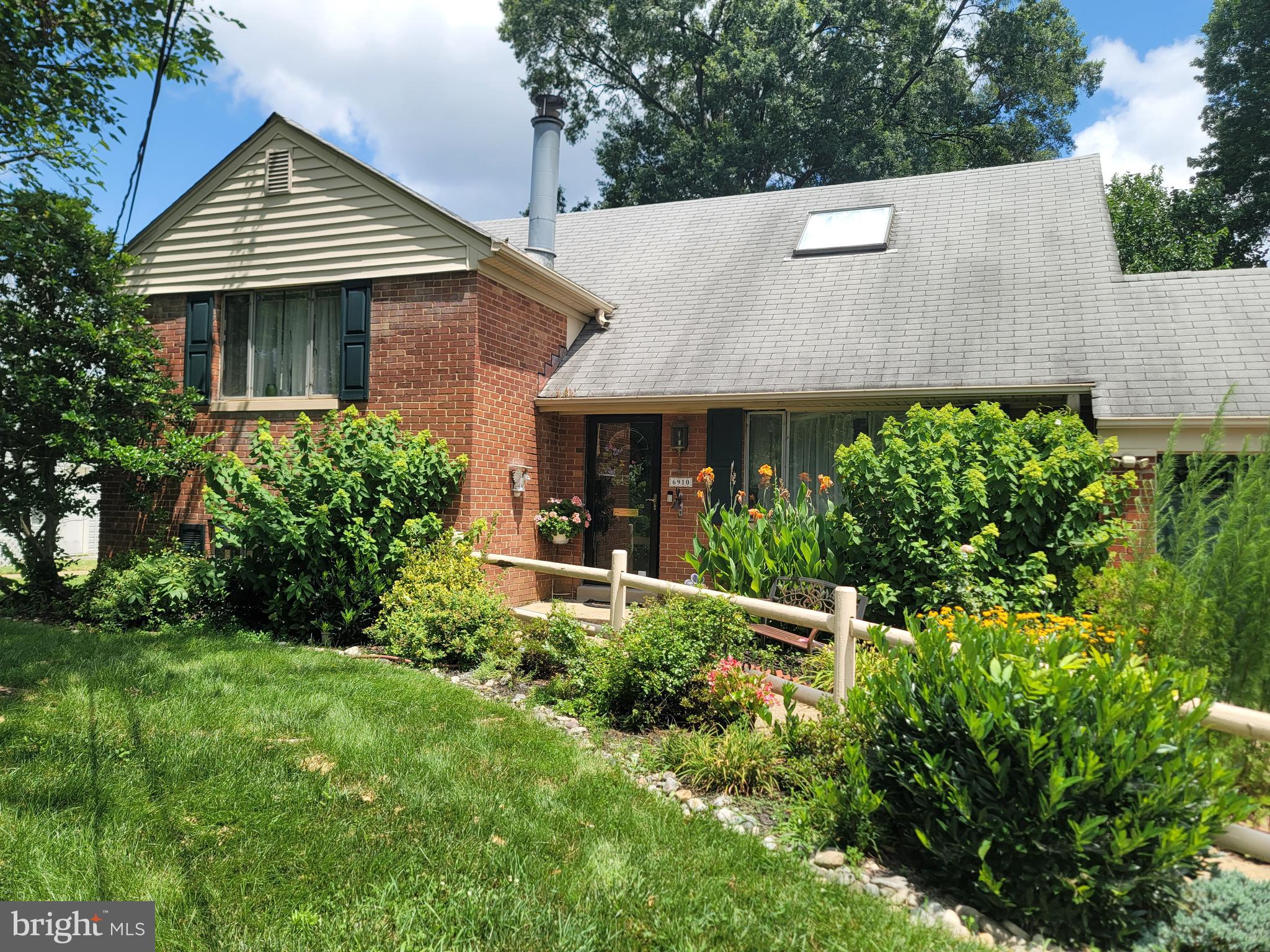 6910 Gilbert Street Springfield, VA 22150 - Photo 4 of 29 a front view of a house with a yard and trees