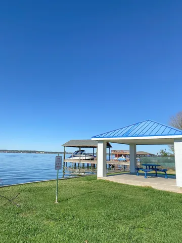 a view of a big room with a big yard and large trees