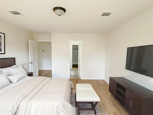 a bedroom with a bed and a flat screen tv