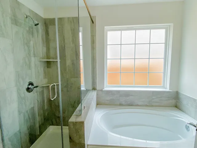 a bath tub sitting next to a window