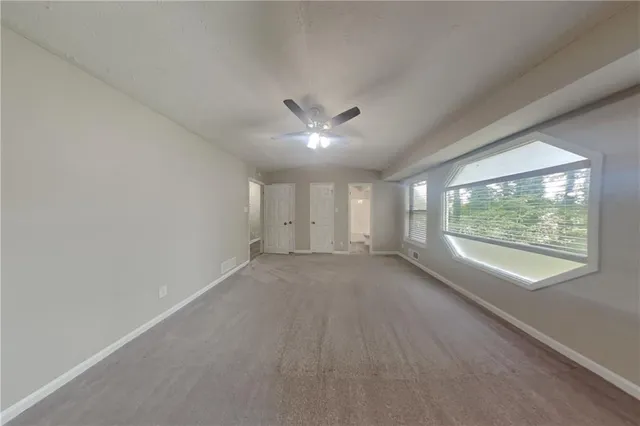 a bathroom with a granite countertop sink toilet a large mirror a bathtub and shower