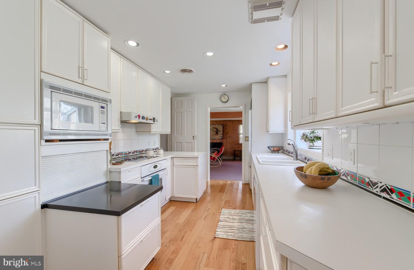 222 Dallam Road Newark, DE 19711 - Photo 11 of 34 a kitchen with white cabinets and appliances