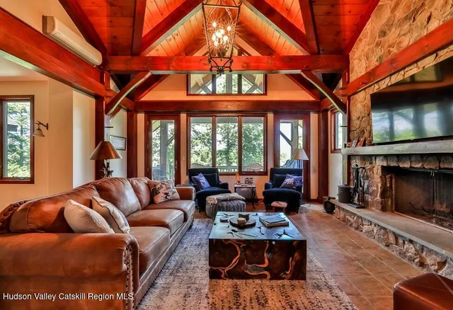 a living room with furniture a fireplace and a flat screen tv
