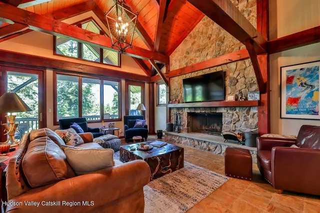 a living room with furniture a flat screen tv and a fireplace