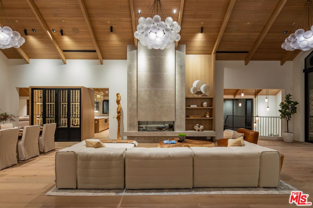 12309 Viewcrest Road Studio City, CA 91604 - Photo 12 of 49 a living room with fireplace furniture and a chandelier