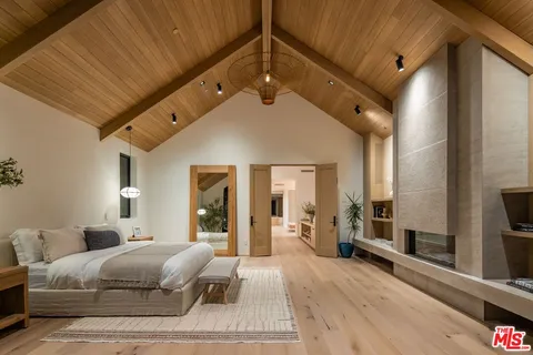 a bedroom with a large bed and a large window