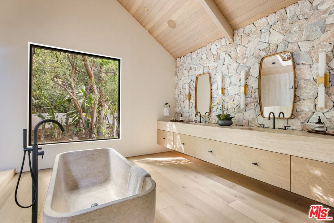 12309 Viewcrest Road Studio City, CA 91604 - Photo 25 of 49 a bathroom with a granite countertop sink mirror and a large window