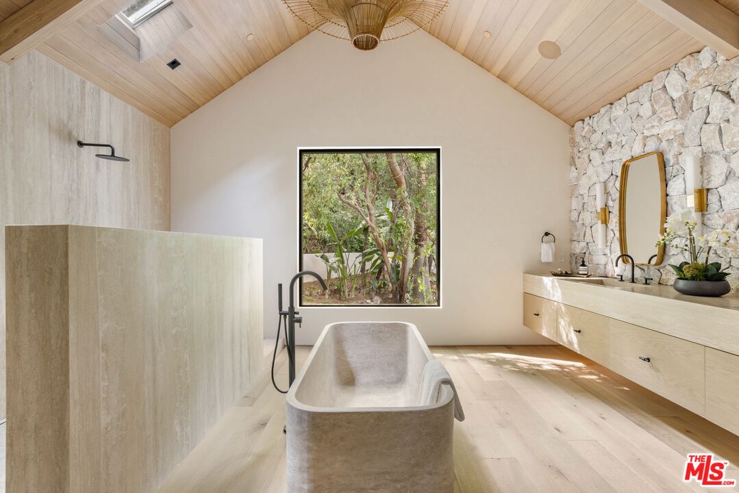 12309 Viewcrest Road Studio City, CA 91604 - Photo 26 of 49 a spacious bathroom with a granite countertop sink a large mirror and a bathtub