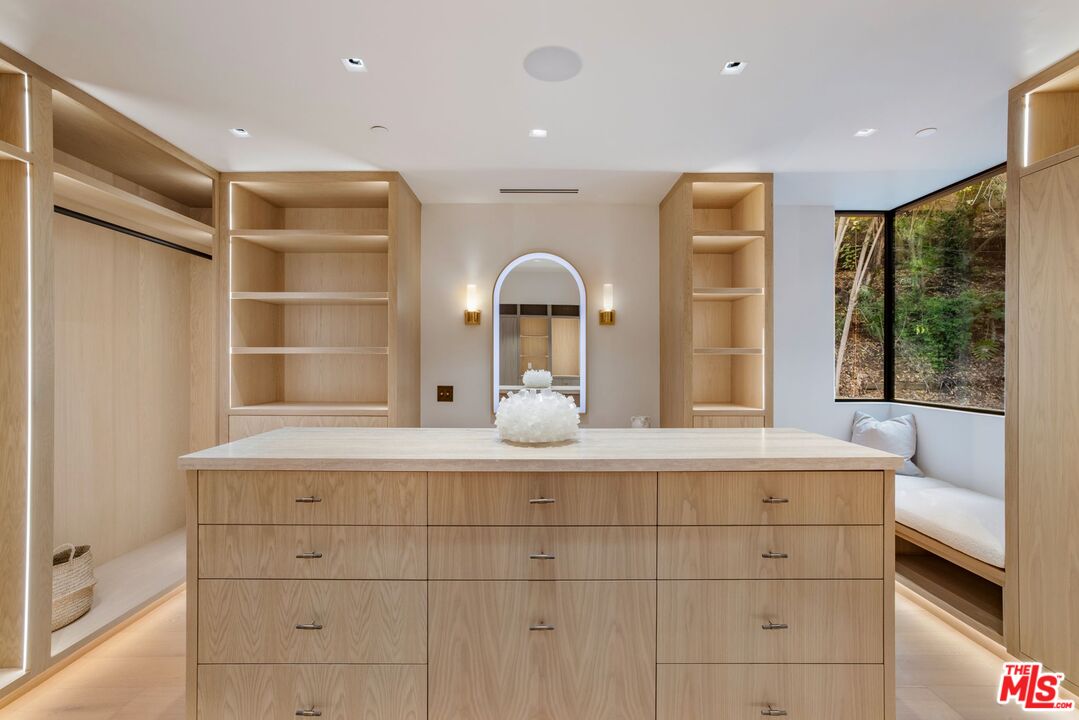 12309 Viewcrest Road Studio City, CA 91604 - Photo 28 of 49 a view of a hallway with a large window and chandelier